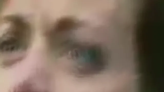 Fix pixelated video example, before: a woman with short auburn hair mid-sentence: the eyes, zoomed in