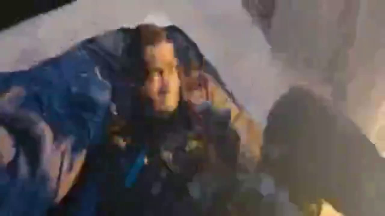 Fix pixelated video example, before: a man lying on a blue sleeping bag in a dark shot, smeared into large blocks before the fix