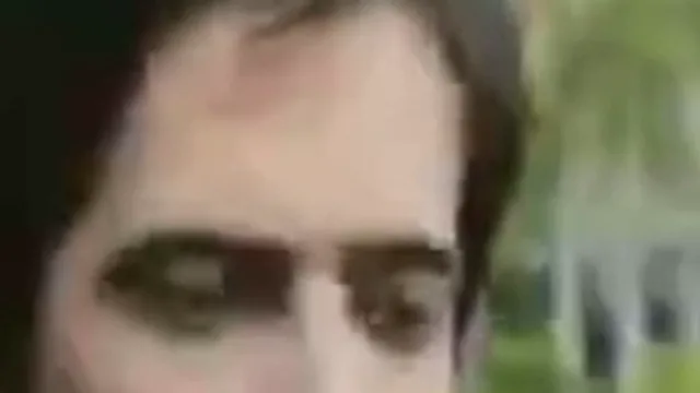 Fix pixelated video example, before: a young man and a woman on an Amsterdam canal street: the eyes, zoomed in