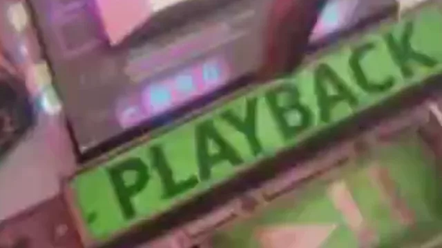 Fix pixelated video example, before: a green PLAYBACK label on a control panel: the lettering, zoomed in